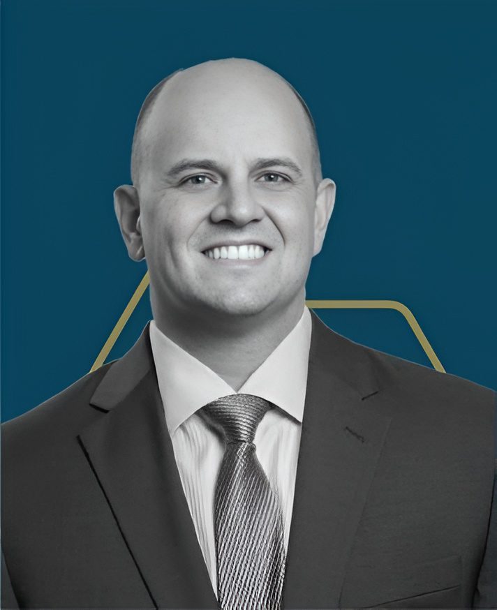 Professional headshot with blue background