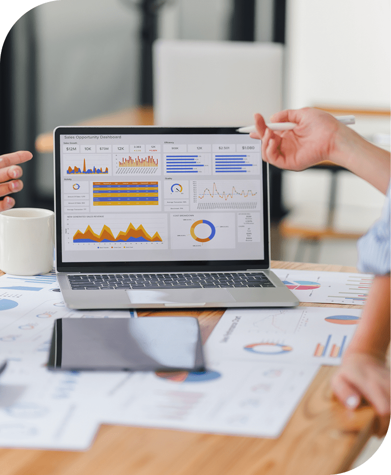 Laptop displaying colorful business data charts